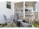 Relaxing screened-in patio with neutral Adirondack chairs and a cozy spot for outdoor entertaining at 332 Tumbling River Dr, Wendell, NC 27591