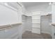 Spacious walk-in closet with built-in shelving and wooden rods for ample storage space at 332 Tumbling River Dr, Wendell, NC 27591