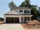 Two-story home with white siding, black shutters and an attached two-car garage at 35 Fetterbush Way, Clayton, NC 27520