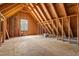 Unfinished attic space framed and ready for customization with a window for natural light at 4012 Old Sturbridge Dr, Apex, NC 27539