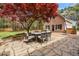 Backyard patio with stone, a dining table and a red Japanese maple tree at 4012 Old Sturbridge Dr, Apex, NC 27539
