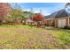 Backyard with grass, trees, a patio, and outdoor chairs at 4012 Old Sturbridge Dr, Apex, NC 27539