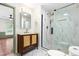 Bathroom features a glass shower with gold fixtures, a dark wood vanity, and marble tile flooring at 4012 Old Sturbridge Dr, Apex, NC 27539