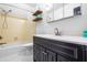 Bathroom with a black vanity, wood shelves, and a shower/tub combination at 4012 Old Sturbridge Dr, Apex, NC 27539