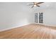Bright bedroom with hardwood floors, a ceiling fan and french doors leading to another room at 4012 Old Sturbridge Dr, Apex, NC 27539