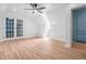 Bright bedroom with hardwood floors, a ceiling fan and blue built-in cabinet at 4012 Old Sturbridge Dr, Apex, NC 27539