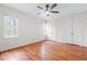 This bright bedroom features hardwood floors, two windows and white double doors at 4012 Old Sturbridge Dr, Apex, NC 27539