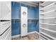 Custom closet features white cabinets, drawers, and shelving with a blue wall at 4012 Old Sturbridge Dr, Apex, NC 27539