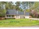 Charming ranch-style home with a well-manicured lawn and mature trees providing shade and curb appeal at 4012 Old Sturbridge Dr, Apex, NC 27539