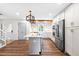 Modern kitchen features an island, stainless steel appliances, and stylish pendant lighting at 4012 Old Sturbridge Dr, Apex, NC 27539