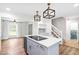 Modern kitchen with center island, wine cooler, and pendant lights at 4012 Old Sturbridge Dr, Apex, NC 27539