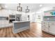 Spacious kitchen with an island, stainless steel appliances, custom cabinets, and hardwood floors throughout at 4012 Old Sturbridge Dr, Apex, NC 27539