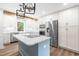 Well-lit kitchen with center island, stainless steel appliances, and a modern design at 4012 Old Sturbridge Dr, Apex, NC 27539