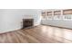 Inviting living room featuring a classic brick fireplace, hardwood floors, and natural light from multiple windows at 4012 Old Sturbridge Dr, Apex, NC 27539