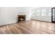 Bright living room features a brick fireplace and large windows at 4012 Old Sturbridge Dr, Apex, NC 27539