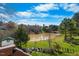 A verdant backyard, featuring a tranquil pond and mature trees at 406 Southshore Pkwy, Durham, NC 27703