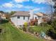 The home's backyard boasts a spacious lawn, a cozy deck, and beautiful landscaping at 406 Southshore Pkwy, Durham, NC 27703