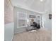 Bright bedroom with modern desk space, large windows and neutral carpet at 406 Southshore Pkwy, Durham, NC 27703