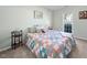 Comfortable bedroom with natural light, featuring a colorful quilt and charming decor at 406 Southshore Pkwy, Durham, NC 27703