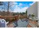 A patio with a view featuring a wooden deck with comfortable seating and a lush garden at 406 Southshore Pkwy, Durham, NC 27703