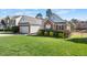 Charming home with brick accents, attached garage, well-manicured lawn and mature landscaping at 406 Southshore Pkwy, Durham, NC 27703