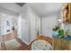 Neutral hallway with hardwood floors, multiple doorways, and decorative accents on a side table at 406 Southshore Pkwy, Durham, NC 27703