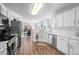 Modern kitchen with white cabinets, stainless steel appliances, and a breakfast nook at 406 Southshore Pkwy, Durham, NC 27703