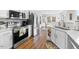 Bright kitchen with stainless steel appliances, double basin sink, and an adjacent dining area at 406 Southshore Pkwy, Durham, NC 27703