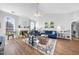 Open-concept living room with fireplace, hardwood floors, and lots of natural light at 406 Southshore Pkwy, Durham, NC 27703