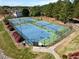 Aerial view of well-maintained community tennis courts surrounded by lush greenery and landscaping at 406 Southshore Pkwy, Durham, NC 27703
