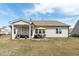 The home's backyard boasts a covered patio and spacious lawn, ideal for relaxing and entertaining at 428 Beaverdam Lake Dr, Fuquay Varina, NC 27526
