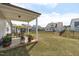 Expansive backyard features a covered patio, lush lawn, and secure fencing for outdoor enjoyment at 428 Beaverdam Lake Dr, Fuquay Varina, NC 27526