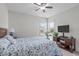 Relaxing bedroom with a ceiling fan, a TV, and a comfortable bed with a blue patterned bedspread at 428 Beaverdam Lake Dr, Fuquay Varina, NC 27526