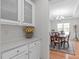 Butler's Pantry featuring white cabinetry with granite countertops and tile backsplash at 428 Beaverdam Lake Dr, Fuquay Varina, NC 27526