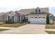 Charming home featuring a two-car garage, well-maintained lawn, and inviting curb appeal at 428 Beaverdam Lake Dr, Fuquay Varina, NC 27526