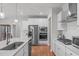 Well-lit kitchen features stainless steel appliances, white cabinetry, and a kitchen island with a sink at 428 Beaverdam Lake Dr, Fuquay Varina, NC 27526