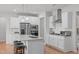Modern kitchen with white cabinets, stainless steel appliances, and a center island with seating at 428 Beaverdam Lake Dr, Fuquay Varina, NC 27526