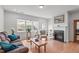 Bright living room with hardwood floors, a fireplace, and a view of the backyard at 428 Beaverdam Lake Dr, Fuquay Varina, NC 27526