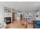 Open-concept living room featuring hardwood floors, fireplace, and seamless access to the kitchen at 428 Beaverdam Lake Dr, Fuquay Varina, NC 27526