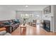 Comfortable living room with hardwood flooring, a fireplace, and abundant natural light at 428 Beaverdam Lake Dr, Fuquay Varina, NC 27526