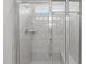 Elegant tiled walk-in shower with glass door and built-in bench, complete with showerhead and fixtures at 428 Beaverdam Lake Dr, Fuquay Varina, NC 27526