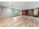 A large basement space with a brick fireplace, neutral walls, and wood-look flooring at 4508 Old Us 421 N, Siler City, NC 27344