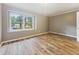 A bright bedroom with wood-look flooring and a large window offering a pleasant view at 4508 Old Us 421 N, Siler City, NC 27344