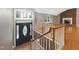 Inviting entryway featuring a decorative front door and stairs leading to an open living space with brick fireplace at 4508 Old Us 421 N, Siler City, NC 27344