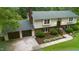 Aerial view of home showcasing manicured lawn, multi-car driveway, and attached garage at 4508 Old Us 421 N, Siler City, NC 27344
