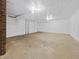 A large garage with a brick wall, concrete floor, and overhead door at 4508 Old Us 421 N, Siler City, NC 27344