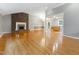 Spacious living room with a brick fireplace, gleaming hardwood floors, and an open floor plan to the dining area at 4508 Old Us 421 N, Siler City, NC 27344