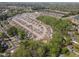 Aerial perspective of a tranquil residential area featuring manicured homes with ponds and trees at 469 Winding Wood Dr, Clayton, NC 27520