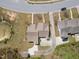 Home aerial showcasing landscaping, pond, and neighborhood street layout, situated in a serene setting at 469 Winding Wood Dr, Clayton, NC 27520