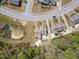 This aerial view shows a well-maintained neighborhood with a pond and mature trees at 469 Winding Wood Dr, Clayton, NC 27520